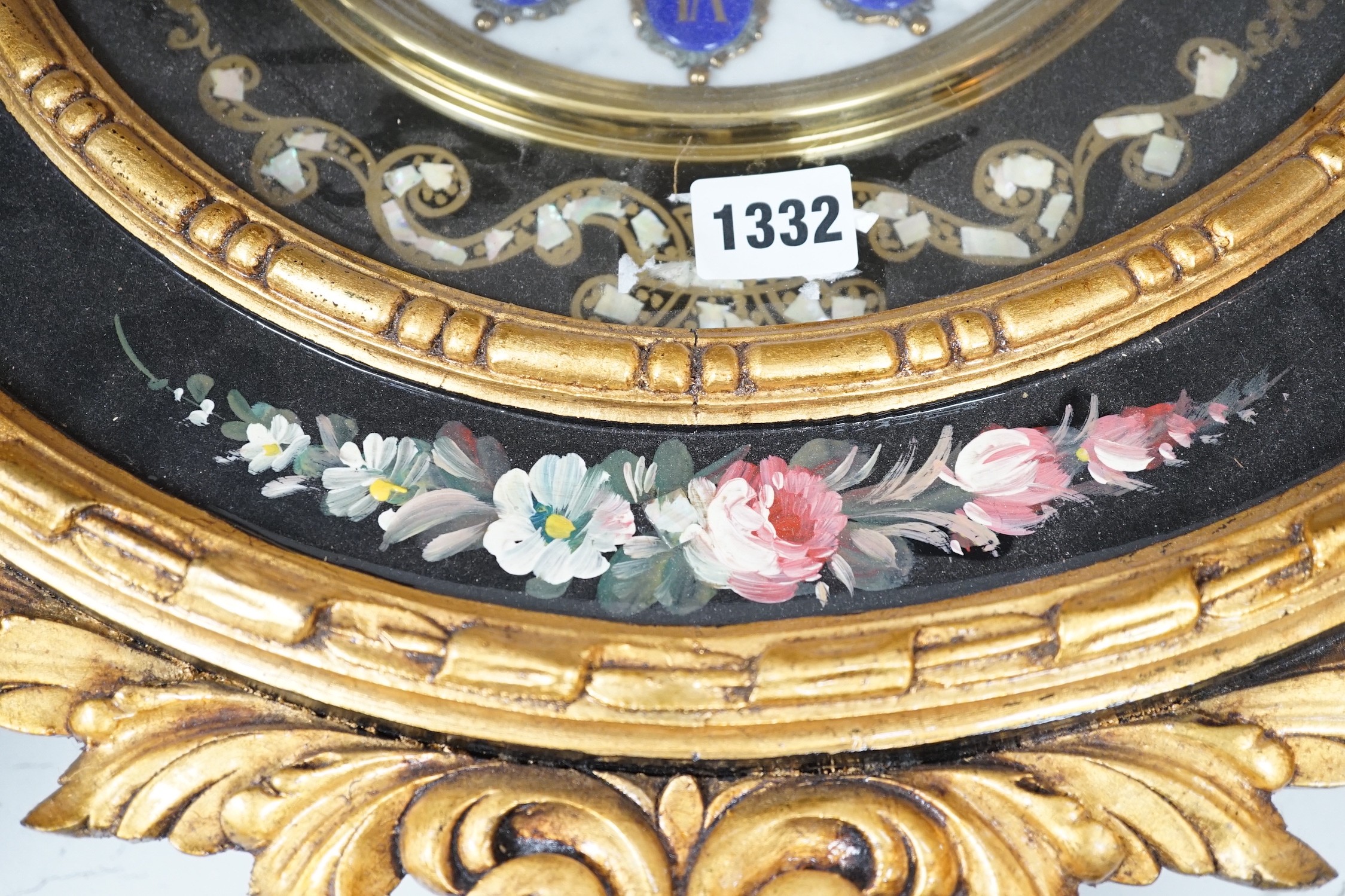 A floral painted clock, length 63cm, quartz movement